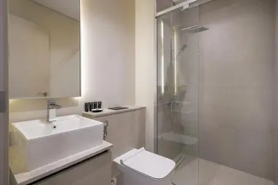 a bathroom with a toilet and a sink and a shower at Mag Eye Townhouse - 2BR & M Room Townhouse - Allsopp & Allsopp in Dubai