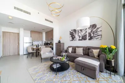 a living room with a couch and a table at Frank Porter - Parkside Rawda 4 in Dubai