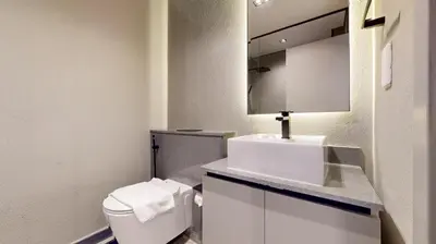 a bathroom with a white toilet and a sink at Mag Eye 910 - Tranquil Studio Apartment in Meydan in Dubai