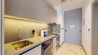 a kitchen with a sink and a counter top at Mag Eye 910 - Tranquil Studio Apartment in Meydan in Dubai