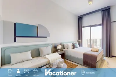 a hotel room with two beds and a couch at Mag Eye 910 - Aesthetic Studio Apartment in Meydan in Dubai