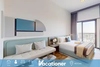 a hotel room with a bed and a couch at Mag Eye 920 - Classy Studio Apartment in Meydan in Dubai
