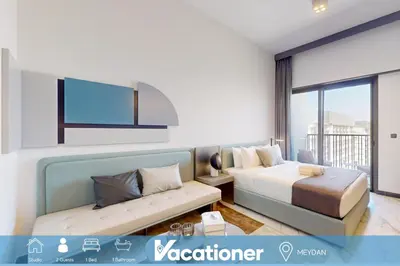 a hotel room with a bed and a couch at Mag Eye 890 - Modern Studio Apartment in Meydan in Dubai