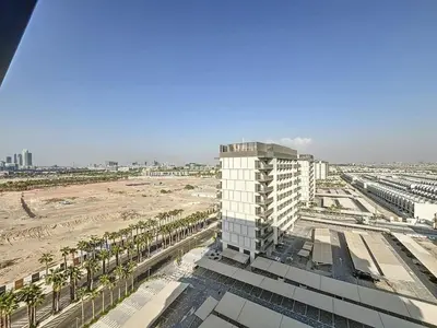an aerial view of a building and a beach at Mag Eye 890 - Modern Studio Apartment in Meydan in Dubai
