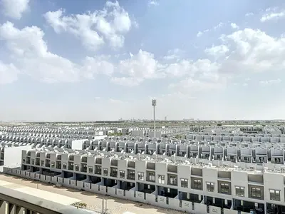 a large white building with a lot of windows at Mag Eye 910 - Peaceful Studio Apartment in Meydan in Dubai