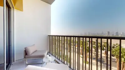 a room with a balcony with a view of the city at Mag Eye 930 - Calm Studio Apartment in Meydan in Dubai
