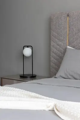 a bed with a white blanket and a lamp on a table at Handsome 1BR in Armada Tower 3 in Dubai