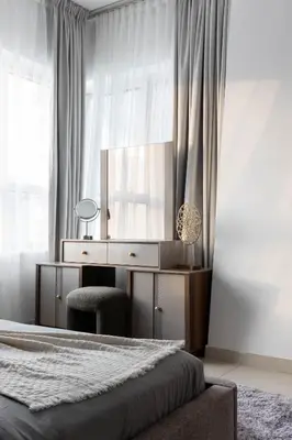a bedroom with a desk and a bed with a mirror at Handsome 1BR in Armada Tower 3 in Dubai