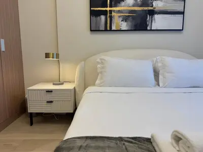 a bedroom with two beds and a lamp on a night stand at Ashri Elegant Studio Near Burj Khalifa in Dubai
