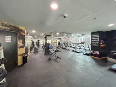 a gym with several treadmills and exercise bikes at Cozy Home at the Heart of Marina on 52nd Floor in Dubai