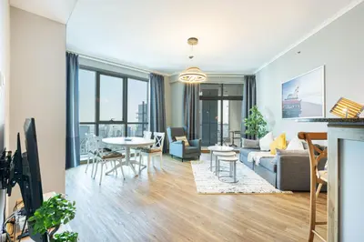 a living room with a couch and a table at Cozy Home at the Heart of Marina on 52nd Floor in Dubai