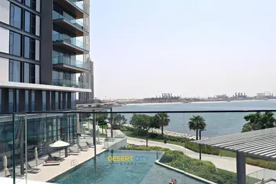 an aerial view of a building with a body of water at Luxurious 2 Bed in Bluewaters, Hosted by Desert City Stays in Dubai