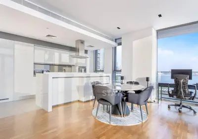 an office with a table and chairs and a desk at Luxurious 2 Bed in Bluewaters, Hosted by Desert City Stays in Dubai