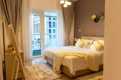 a bedroom with a bed and a large window at Chic Dubai Marina Stay in Dubai