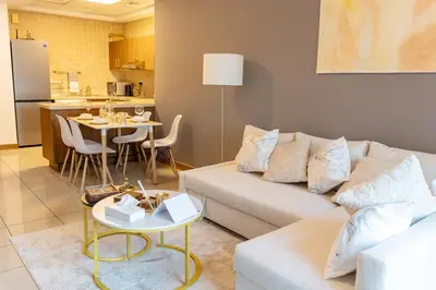 a living room with a couch and a table at Chic Dubai Marina Stay in Dubai
