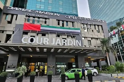 a building with a car parked in front of it at Studio with Terrace Damac Maison Cour Jardin Business Bay in Dubai