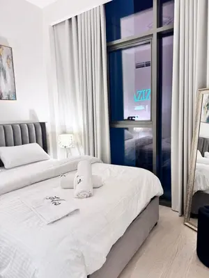 a hotel room with two beds and a window at Burj Khalifa view modern 1BHK with balcony in Dubai