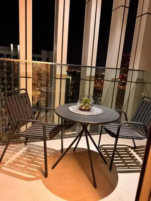 a table and two chairs on a balcony at Burj Khalifa view modern 1BHK with balcony in Dubai