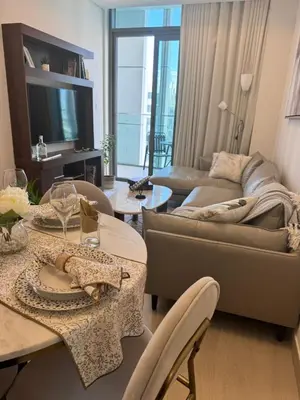 a living room with a couch and a table at Burj Khalifa view modern 1BHK with balcony in Dubai