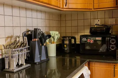 a kitchen counter top with a coffee maker and utensils at Lux two br w Sea Views from rooms in Dubai Marina in Dubai