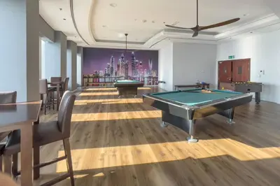a billiard room with a pool table and some tables at Lux two br w Sea Views from rooms in Dubai Marina in Dubai
