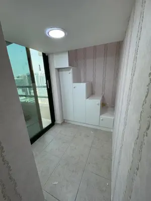 an empty room with a large window and white cabinets at Loft bed short and long stay in Dubai