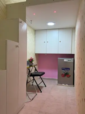 an empty room with a table and a refrigerator at Loft bed short and long stay in Dubai