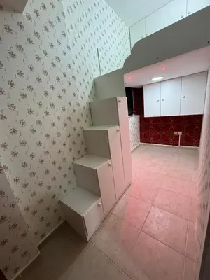 an empty room with stairs in a room with a kitchen at Loft bed short and long stay in Dubai