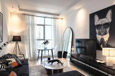 a living room with a dog laying on a table at Ultra-Chic 1BR Near Marina & Beach Walk in Dubai
