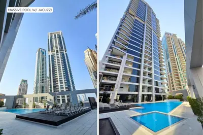 a building with a pool in front of a city at Ultra-Chic 1BR Near Marina & Beach Walk in Dubai