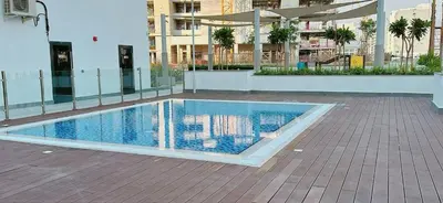 a swimming pool in the middle of a building at Elegant Studio Apartment In Meydan One in Dubai