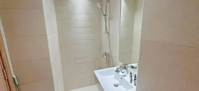 a bathroom with a sink and a shower at Elegant Studio Apartment In Meydan One in Dubai
