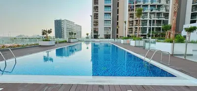 a large swimming pool on the roof of a building at Elegant Studio Apartment In Meydan One in Dubai