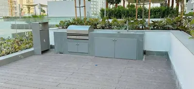 a outdoor kitchen with a sink and a counter at Elegant Studio Apartment In Meydan One in Dubai