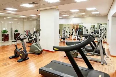 a gym with several treadms and cardio machines at Prime retreats - steps to Grosvenor Hotel in Dubai