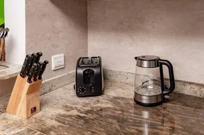 a kitchen counter with a toaster and a blender at Prime retreats - steps to Grosvenor Hotel in Dubai