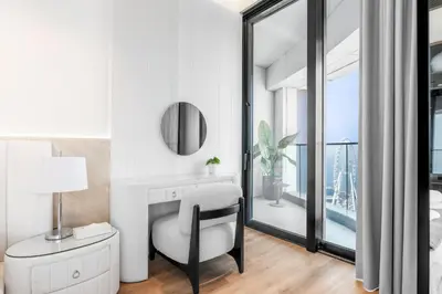 a white room with a chair and a mirror at Address JBR, Beach View, Jumeirah Beach Residence - Mint Stay in Dubai