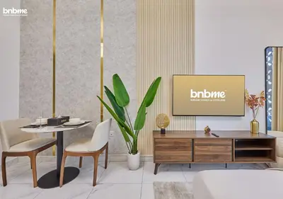 a living room with a tv and a table and chairs at bnbmehomes - Serenity Lakes 5 in Dubai