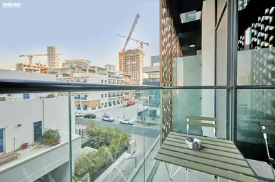a balcony with a bench and a view of a city at bnbmehomes - Serenity Lakes 5 in Dubai
