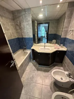 a bathroom with a sink and a tub and a toilet at Marina Comfort Room with Bath inside in Dubai