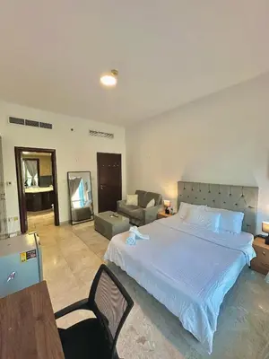 a bedroom with a large bed and a living room at Marina Comfort Room with Bath inside in Dubai
