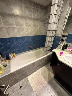 a bathroom with a bath tub and a sink at Marina Comfort Room with Bath inside in Dubai