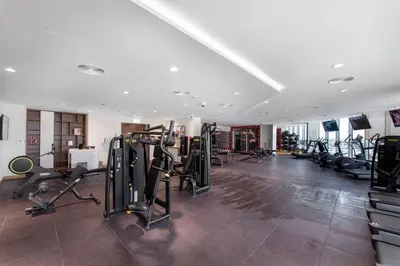 a gym with treadmills and ellipticals in a room at GLOBALSTAY Palm View in Dubai