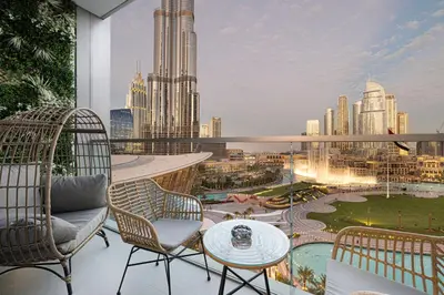 a balcony with chairs and a table and a view of a city at Grande Signature by Emaar! Best Full Burj Khalifa, Fountains, Park View! in Dubai