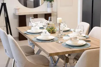a wooden table with chairs and a dining room at Grande Signature by Emaar! Best Full Burj Khalifa, Fountains, Park View! in Dubai