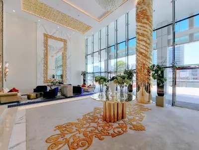 a lobby with a table with flowers on it at DAMAC MAISON PRIVE - Lake View in Dubai