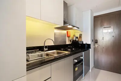 a kitchen with a sink and a stove at DAMAC MAISON PRIVE - Lake View in Dubai