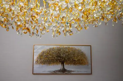 a painting of a tree under a chandelier at Luxury Haven 2BR I Damac Vera I City Views in Dubai