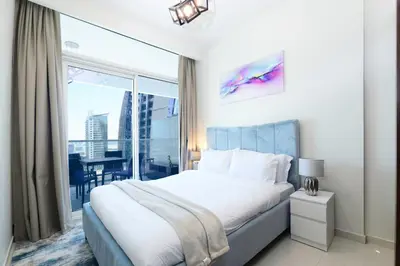 a bedroom with a large bed and a large window at Luxury Haven 2BR I Damac Vera I City Views in Dubai