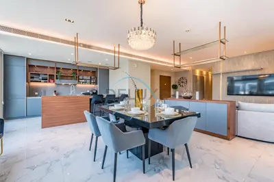 a dining room and kitchen with a table and chairs at Radiant 2BR with Assistant Room at Citywalk Residential Building 7, Al Wasl by Deluxe Holiday Homes in Dubai